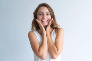 A woman holding her cheeks.