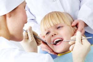 A dentist examining a child's teeth.