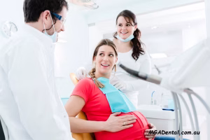 A woman in a chair with a dentist and a woman in a chair.