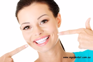 A woman pointing at her teeth.